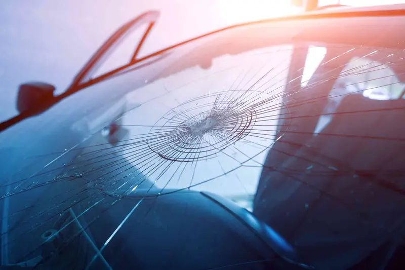 A stone chip with cracks radiating across a windscreen